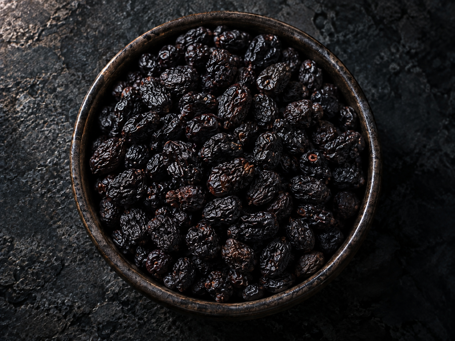 Dried blueberries in a dark bowl